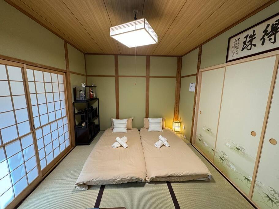 Postel nebo postele na pokoji v ubytování 木香の家-天下茶屋