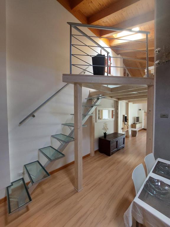 a loft with a staircase and a living room at Loft Open Space Adele -Tirano Centro Storico in Tirano