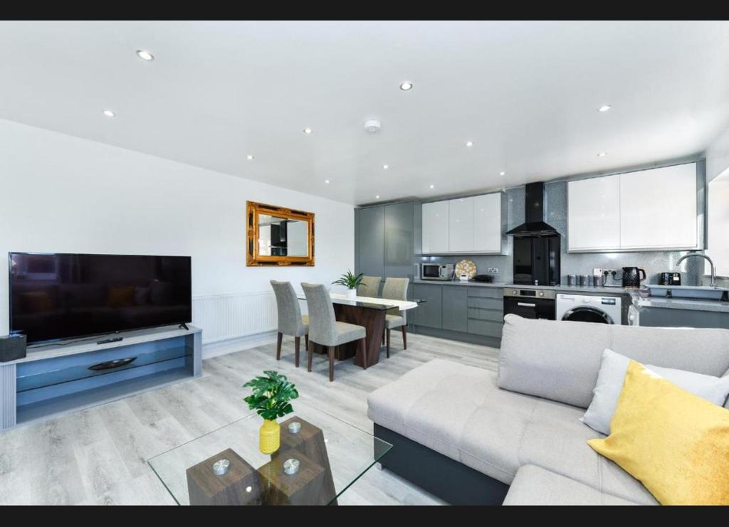 a living room with a couch and a table and a kitchen at Windmill Villa in Warsop