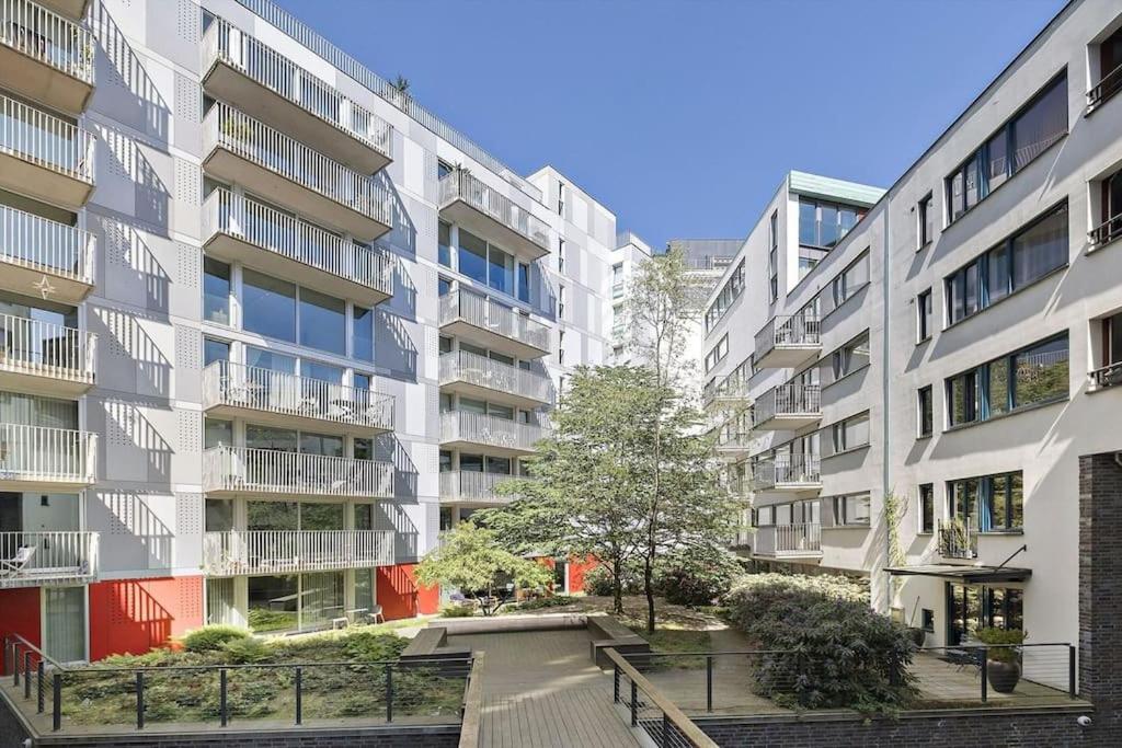 an apartment building with a staircase in front of it at Tjuvholmen - balcony with seaview & 2 bedrooms in Oslo