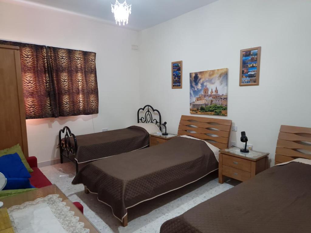 Postel nebo postele na pokoji v ubytování Saracini's Homestay