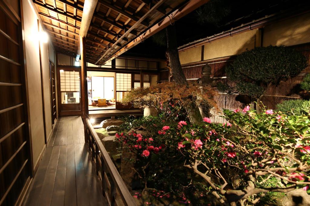 a room with flowers and plants in a building at Show-an Machiya Inn in Kyoto