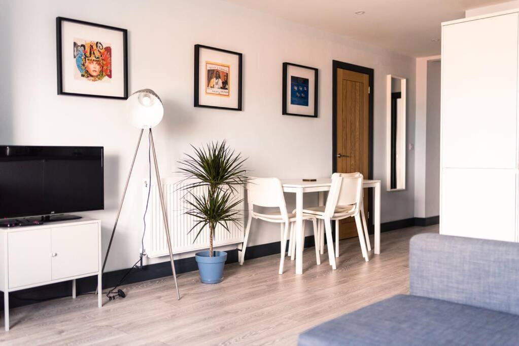 a living room with a table and chairs and a television at The Seaview Apartment - Margate Beach - By Goldex Coastal Breaks in Kent