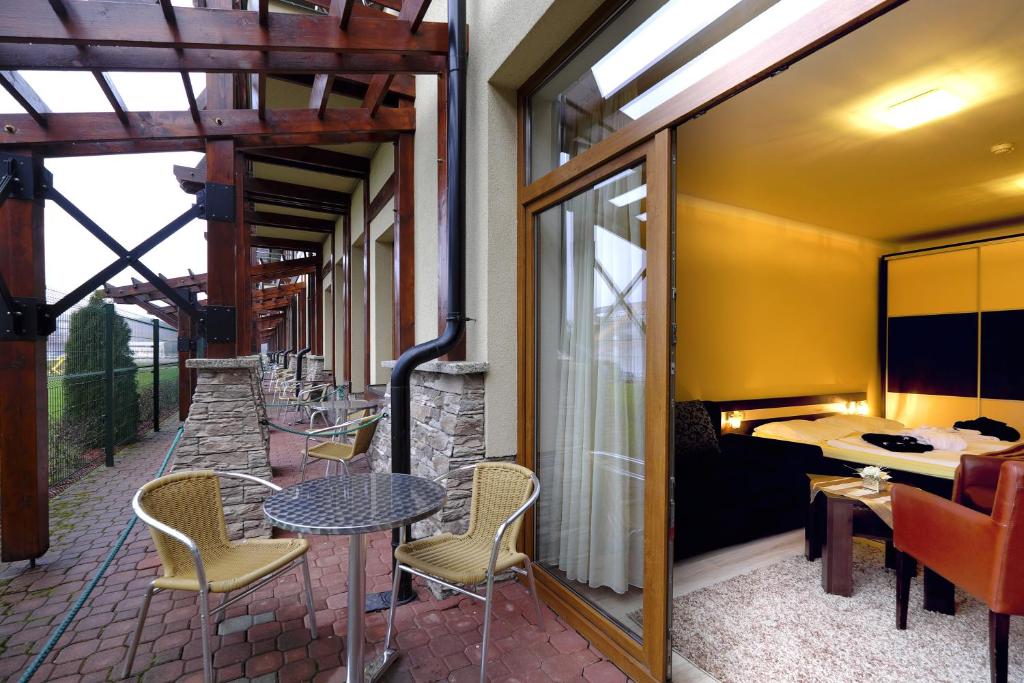 a patio with a table and chairs on a patio at Luxury Apartment Krištof in Bešeňová