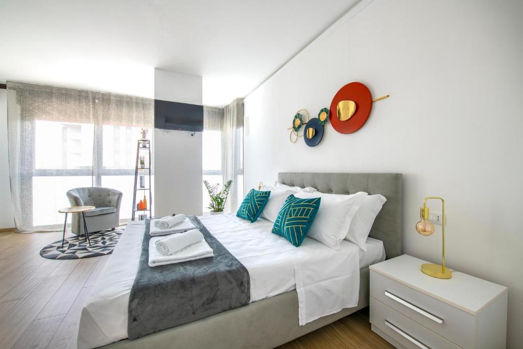1 dormitorio con 1 cama con almohadas blancas y azules en -Free Parking-City-Center-Strategic Apartment, en Verona