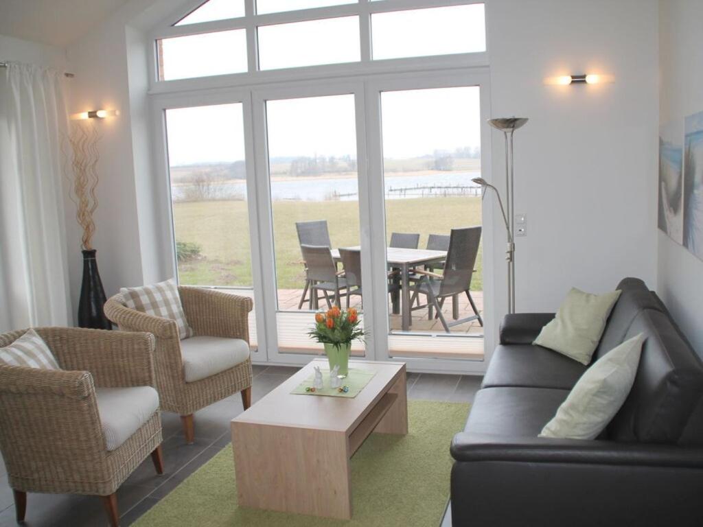 a living room with a couch and chairs and a table at Luxury holiday house "Schleibrise" in Hestoft