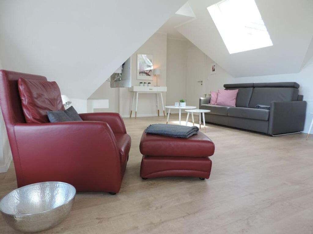 a living room with two chairs and a couch at Penthaus an der Harle in Carolinensiel