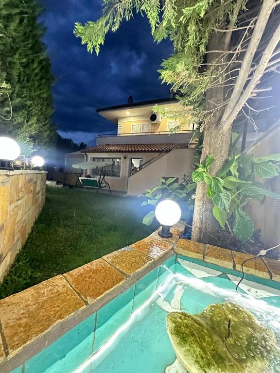 a house with a swimming pool at night at Apartment Countryside in Velabishti
