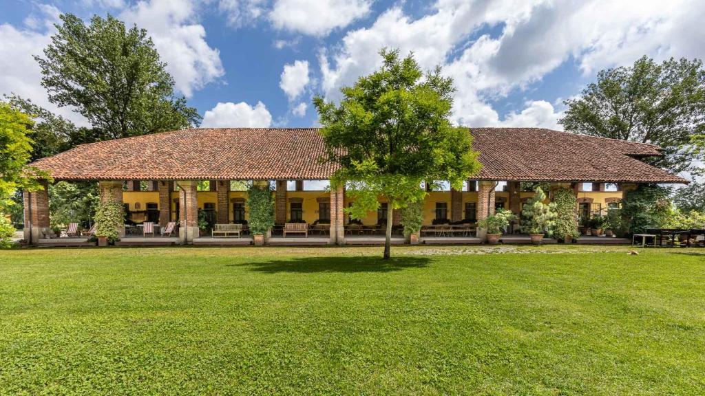a house with a tree in the yard at Cascina Gaggioli in Milan