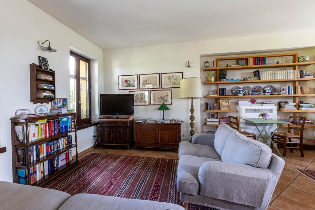 a living room with a couch and a tv at Cascina Gaggioli in Milan