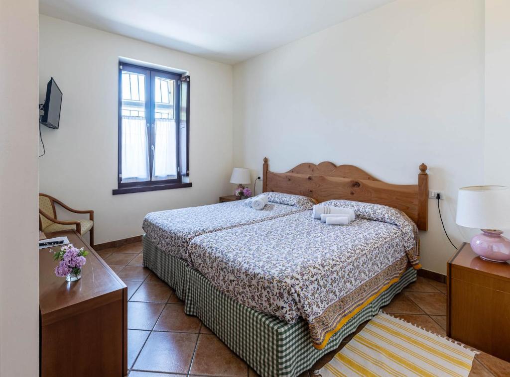 a bedroom with a large bed and a window at Cascina Gaggioli in Milan