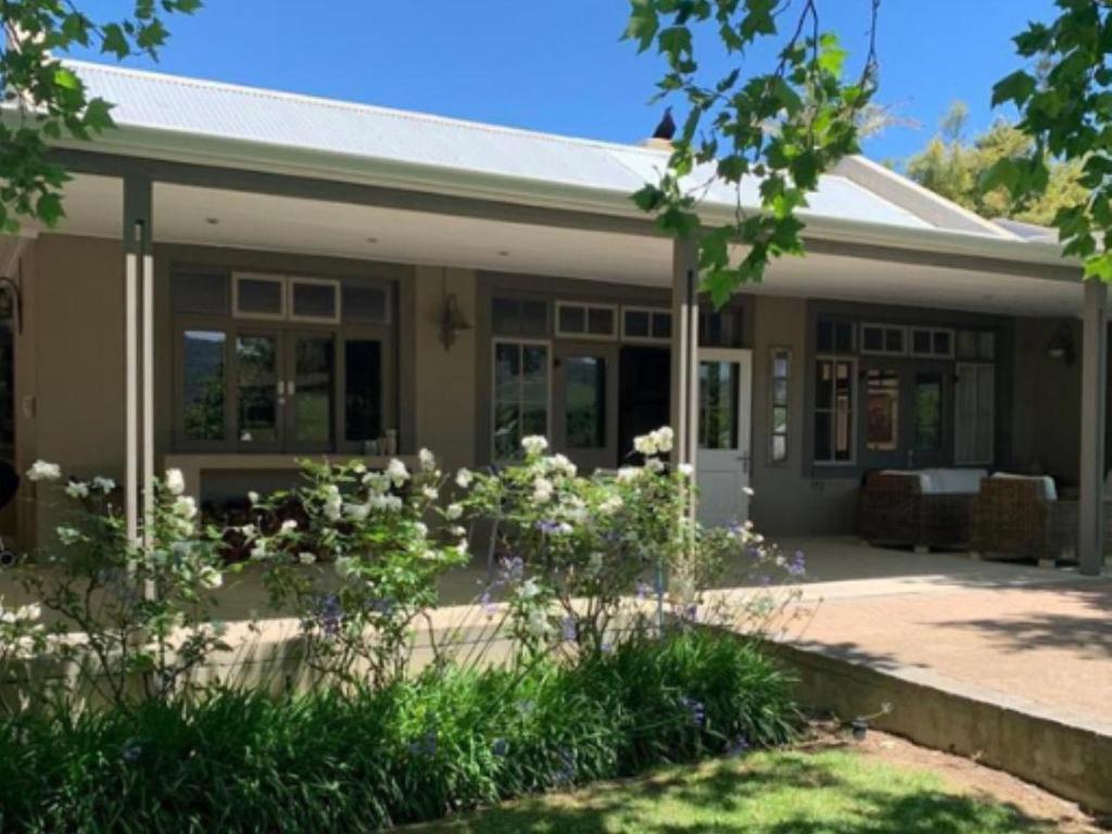 a house with white flowers in front of it at Madajo in Stellenbosch