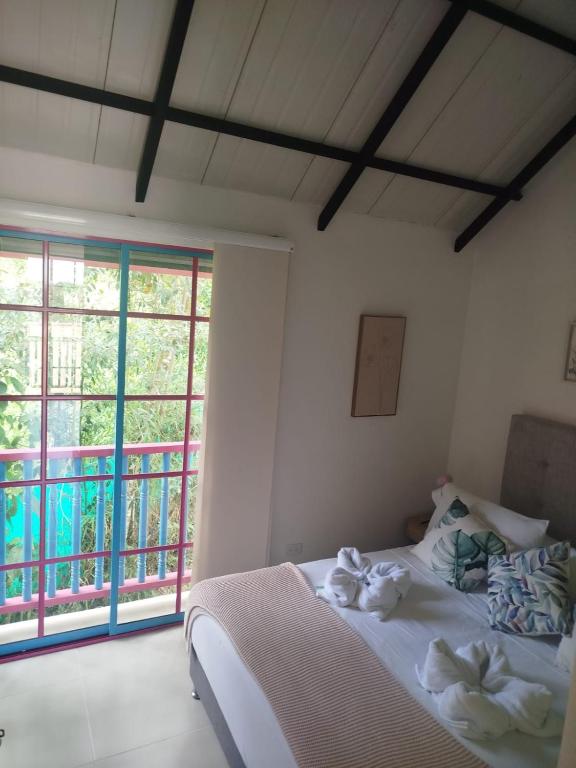 a bedroom with a bed with towels on it at Apartamento amplio cerca al parque Guatape - Pajaros in Guatapé
