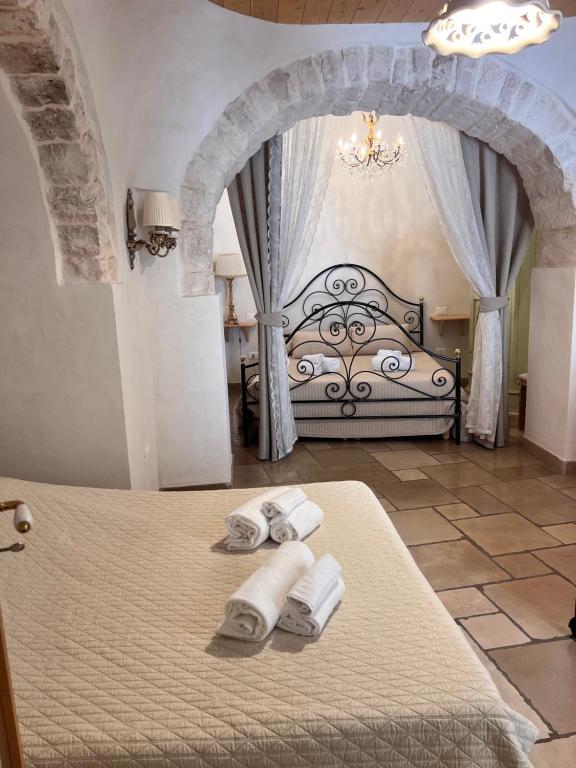 Postel nebo postele na pokoji v ubytování Resort Romano in Trulli
