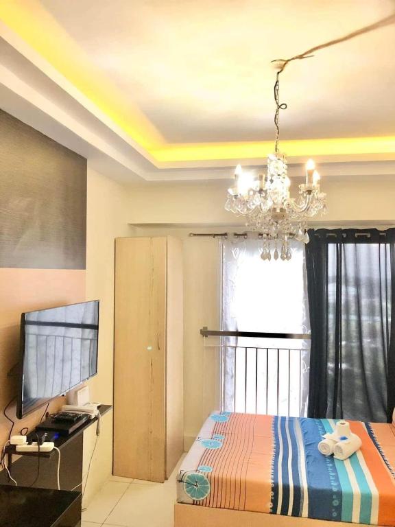 Postel nebo postele na pokoji v ubytování JRT Suites Tagaytay