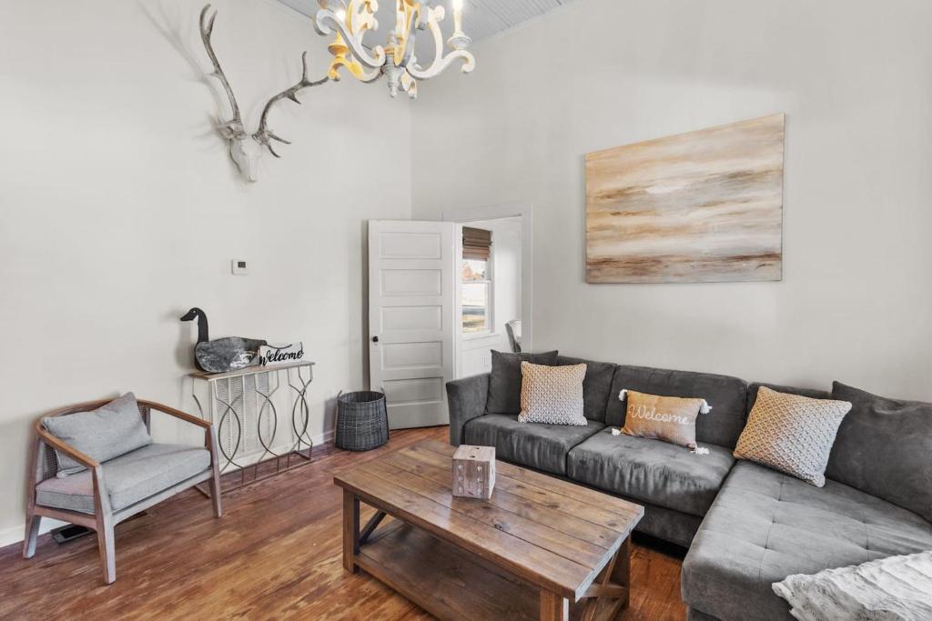 a living room with a couch and a table at Southern Magnolia House With Porch Swing in Mooringsport