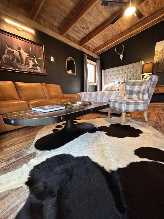 a living room with a couch and a table at River View, Red River Carriage House in Shreveport