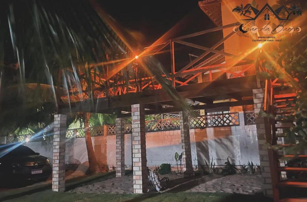a building with a car parked in front of it at Luar Da Barra in Barra Grande