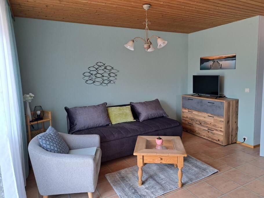 a living room with a couch and a table at Ferienwohnung direkt am See 2 in Altmünster
