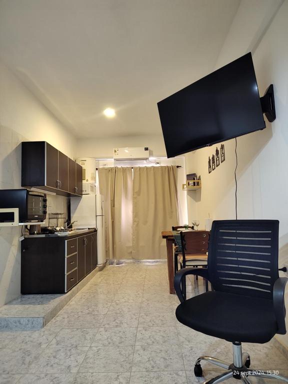 a kitchen with a chair and a table in it at Departamento en Planta baja, centrico, cochera cubierta Sarmiento265apart D5 in San Fernando del Valle de Catamarca