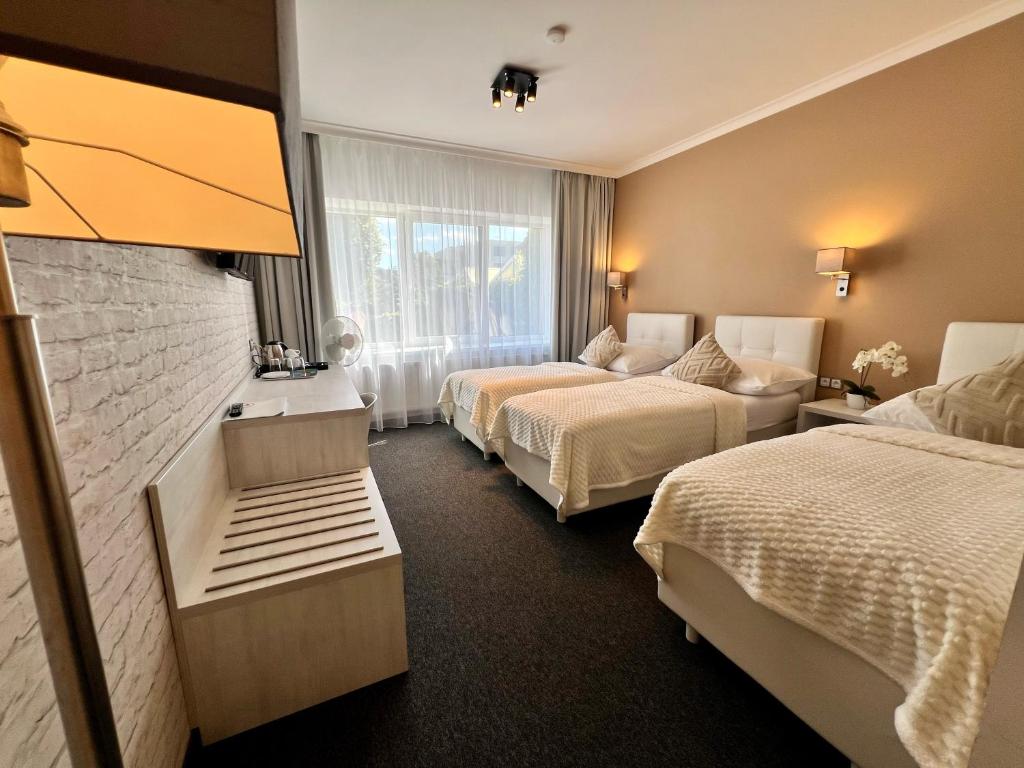 Postel nebo postele na pokoji v ubytování Grand Petit Hotel ex Shato Gesson