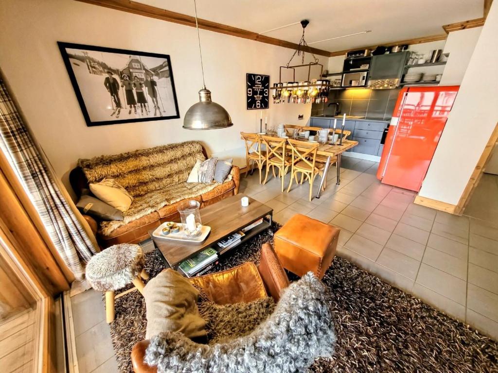 a living room with a couch and a table at Appartement montagnard 4* cosy, 2 ch, 6 pers - FR-1-598-6 in Les Gets