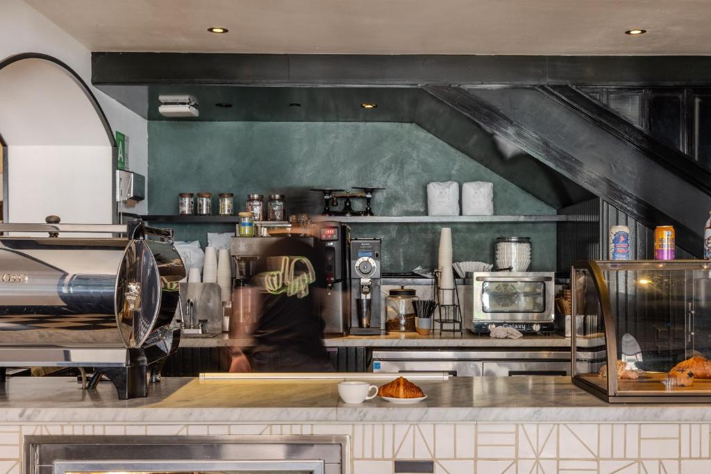 a kitchen with a person standing in the kitchen at STILE Downtown Los Angeles by Kasa in Los Angeles