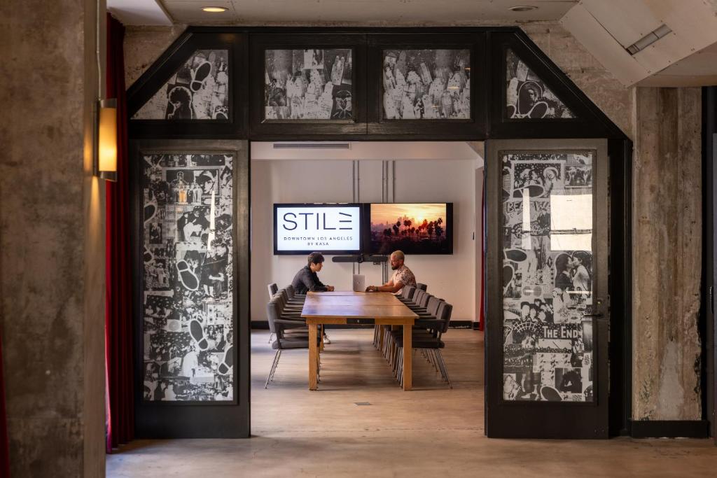two people sitting at a table in a room at STILE Downtown Los Angeles by Kasa in Los Angeles