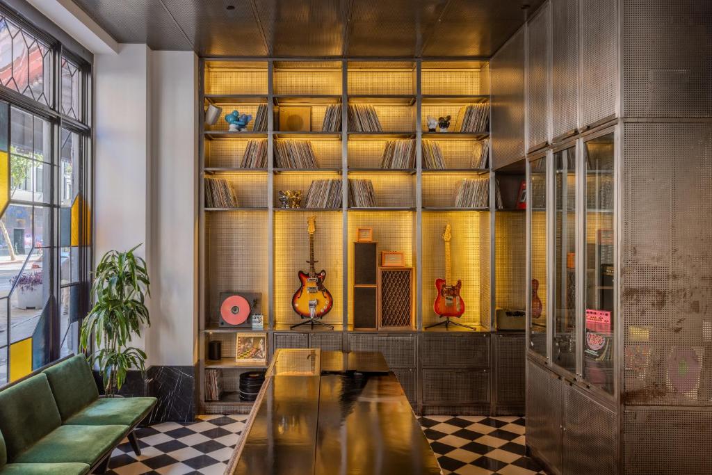 a room with three guitars on a wall at STILE Downtown Los Angeles by Kasa in Los Angeles