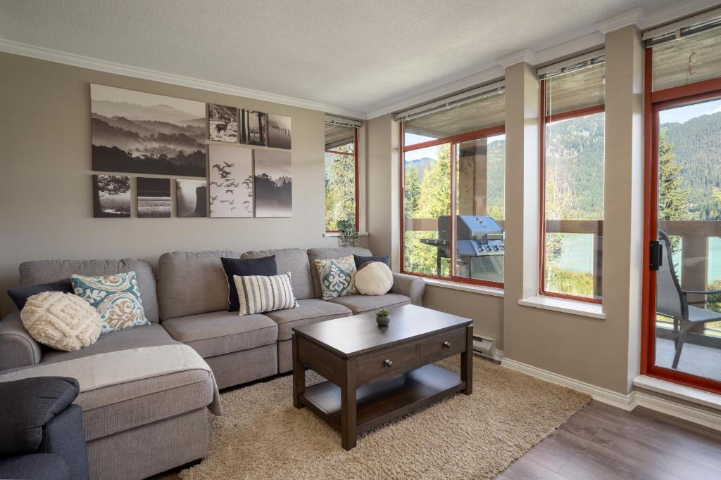 a living room with a couch and a coffee table at 2BR - Located in beautifully acclaimed Nicklaus North Golf Clubhouse in Whistler
