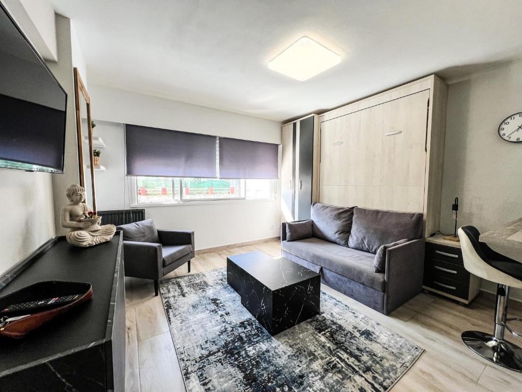 a living room with a couch and a table at The Olive Loft in Vigo