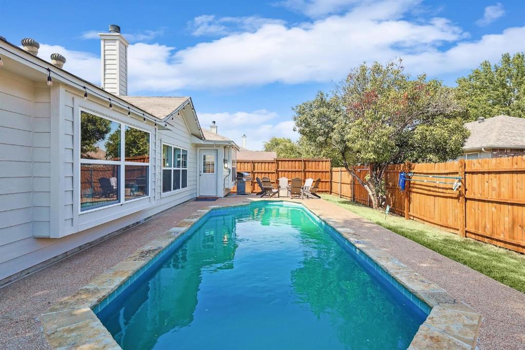 een zwembad in de achtertuin van een huis bij 4BD 2BA Saginaw Sanctuary - Pool Firepit Laundry in Saginaw