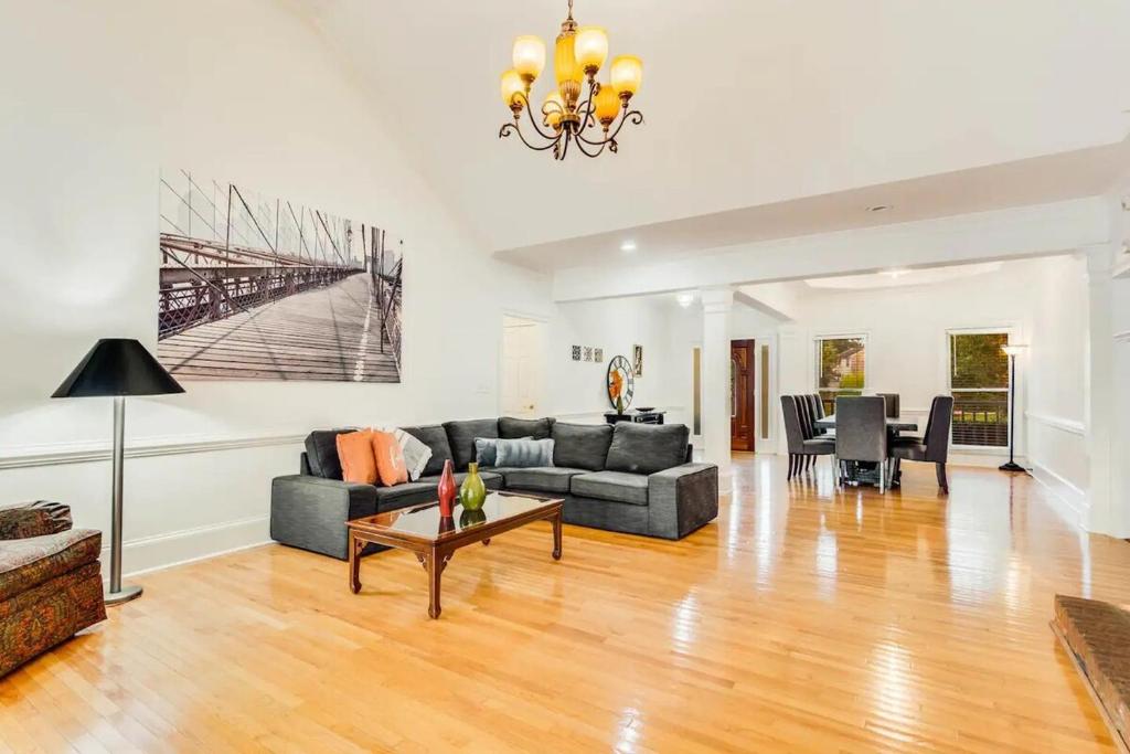 a living room with a couch and a table at Atlanta 5BR Luxe Pool Retreat,Sleeps 12 in Conyers