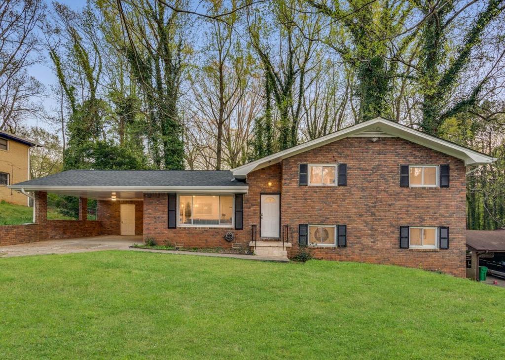 a brick house with a lawn in front of it at Spacious Decatur Home Sleeps 12, Work-Ready in Decatur