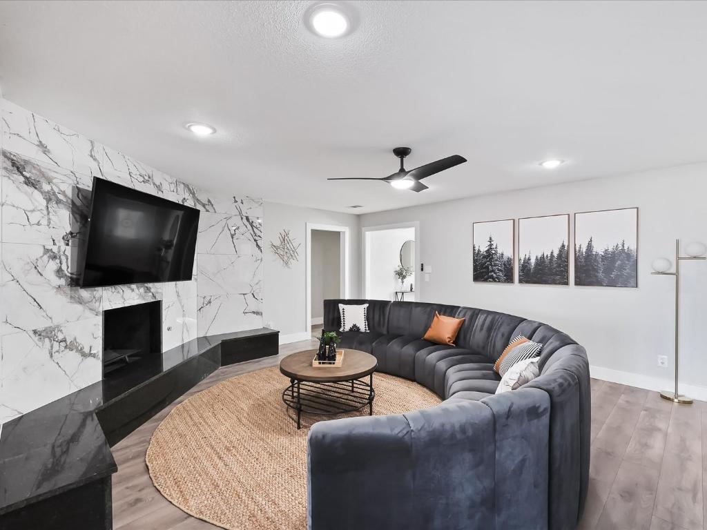 a living room with a couch and a tv at Ridgefield Estate 5BED Backyard Games in Plano