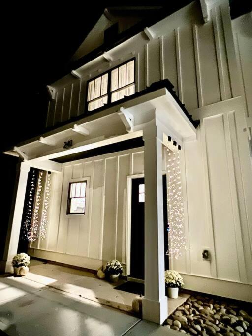 a house with a front porch with lights on it at Charming Gainesville Townhome 3 in Gainesville