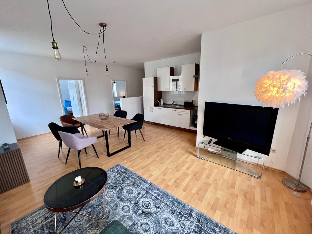 a living room with a dining table and a television at Apartment in Grimma mit 2 Schlafzimmer in Grimma