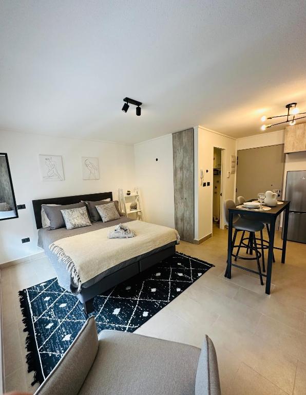a bedroom with a bed and a table in it at Departamento Estudio in Concepción