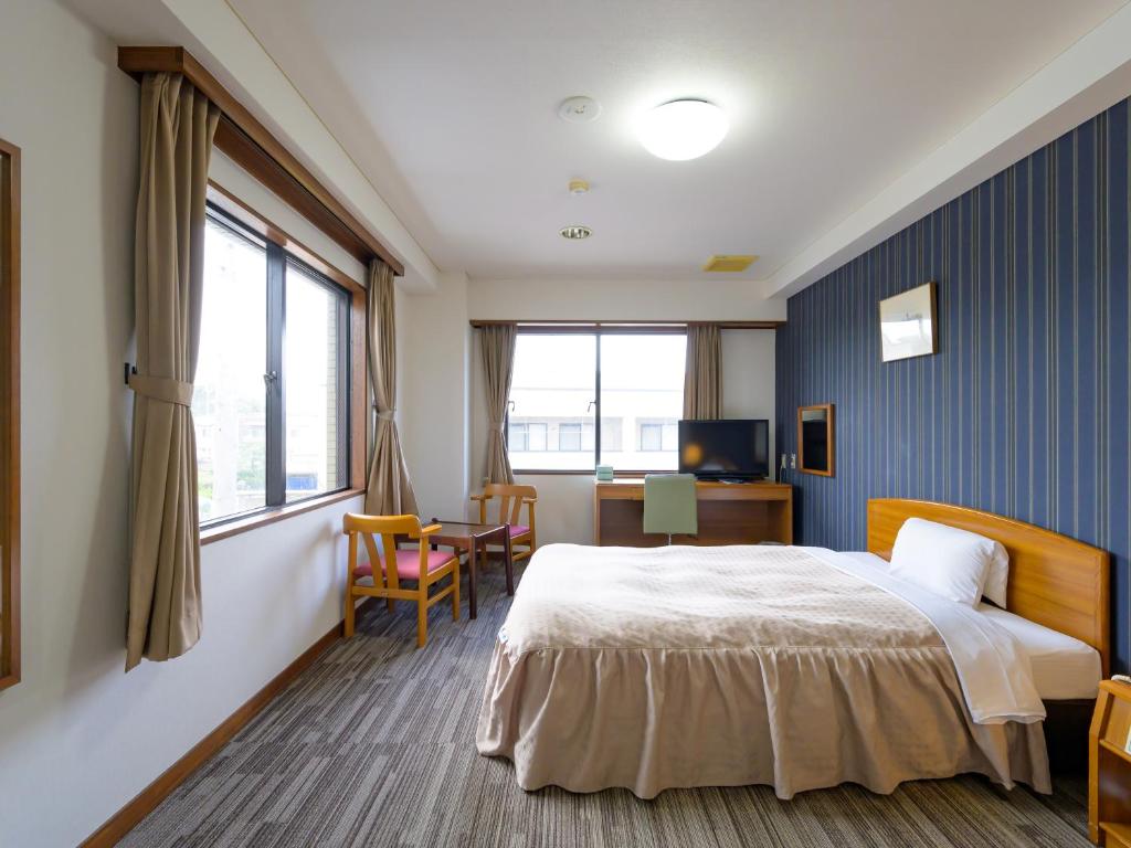 Postel nebo postele na pokoji v ubytování Hisai Green Hotel