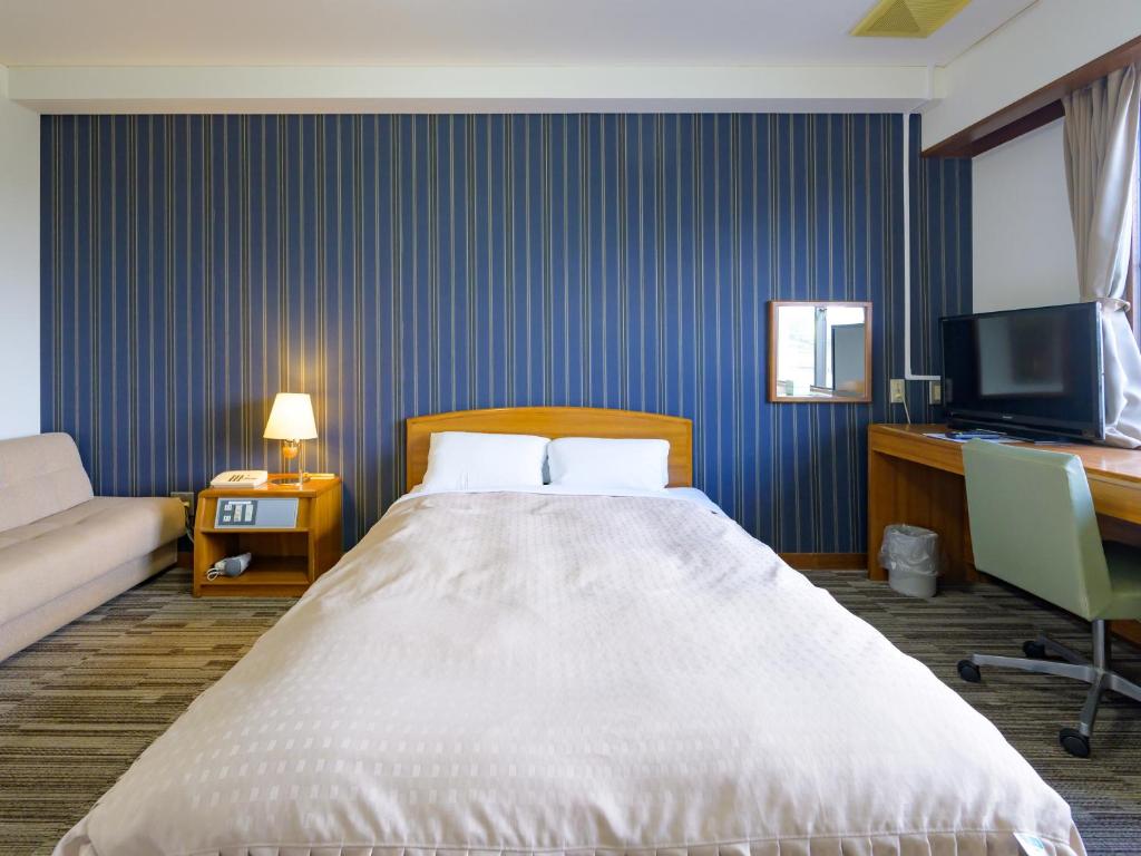 Postel nebo postele na pokoji v ubytování Hisai Green Hotel