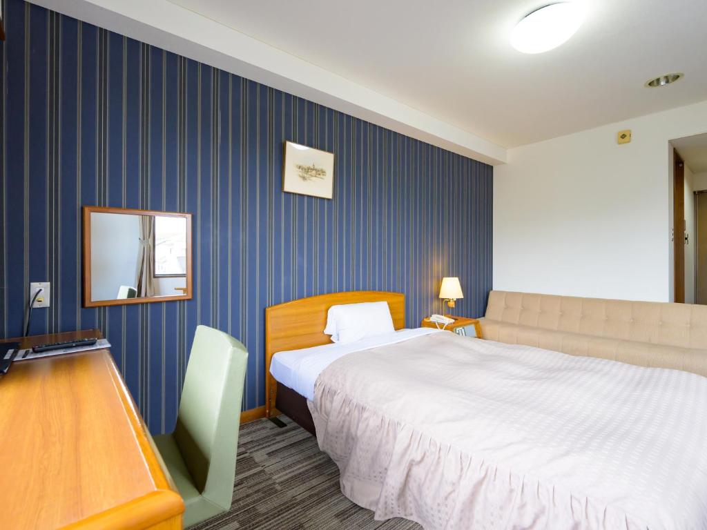 Postel nebo postele na pokoji v ubytování Hisai Green Hotel