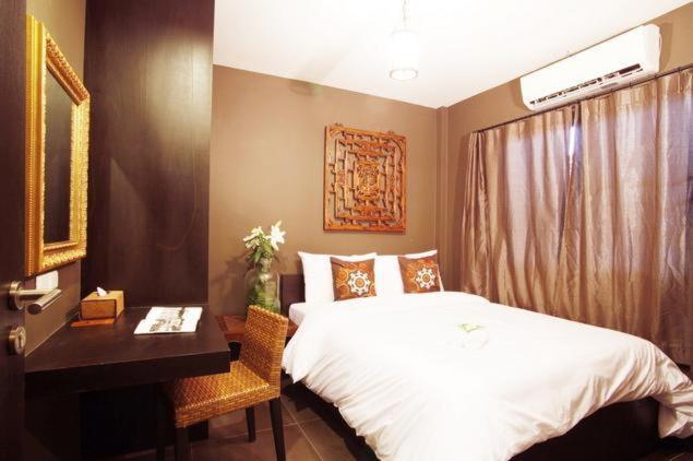 Postel nebo postele na pokoji v ubytování Lilu Chiang Mai