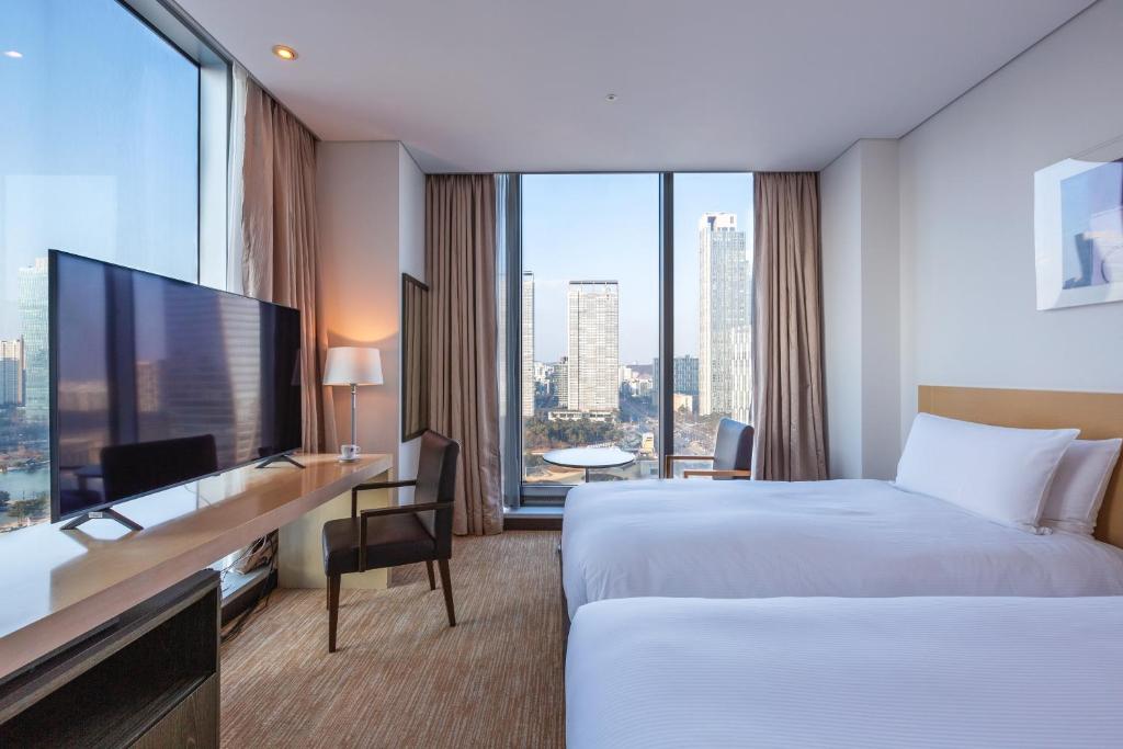 Postel nebo postele na pokoji v ubytování Orakai Songdo Park Hotel