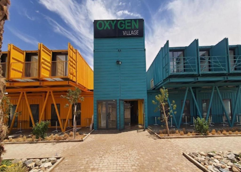 a building with a sign that reads oxygen village at Oxygen Village in Zeïda