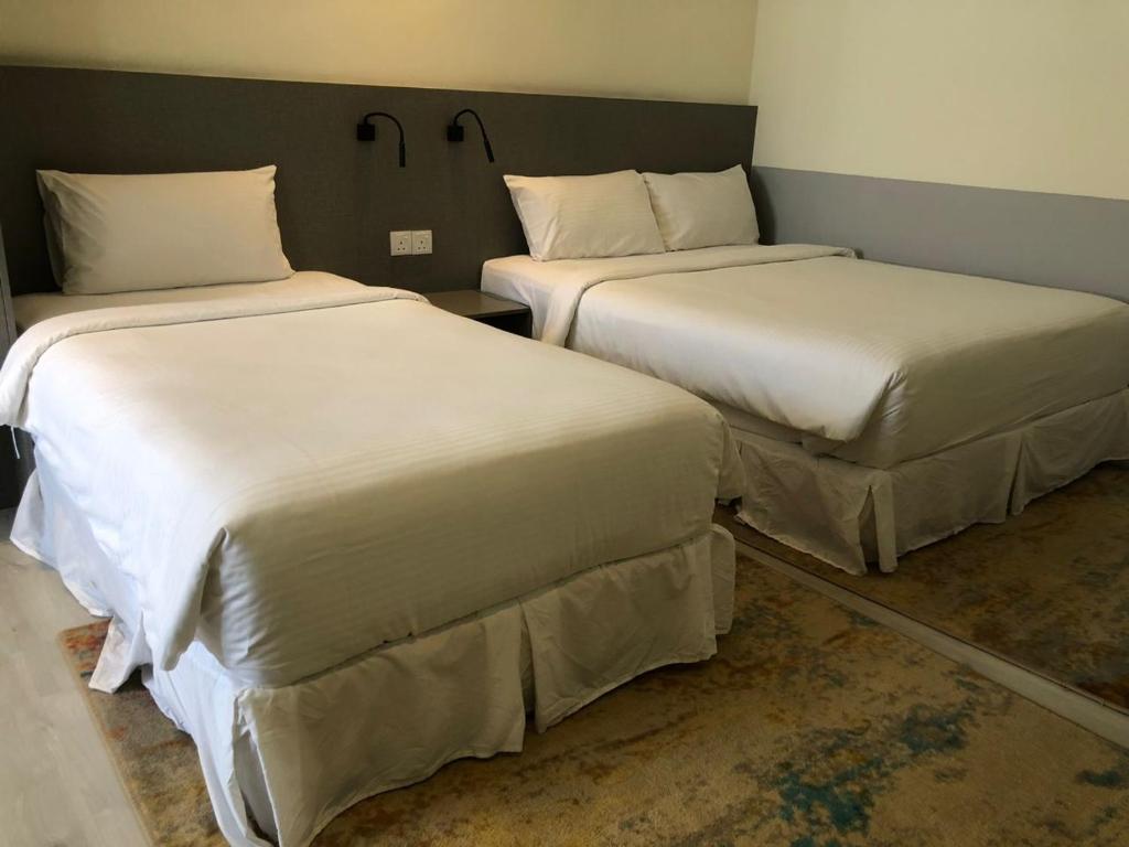 Postel nebo postele na pokoji v ubytování Hutton Suite Hotel Managed by The Ascott Limited