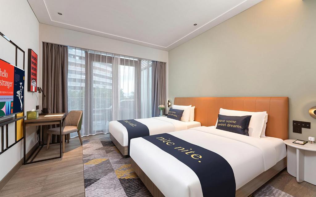 Postel nebo postele na pokoji v ubytování The Mustel Hotel Chongqing Hongyadong