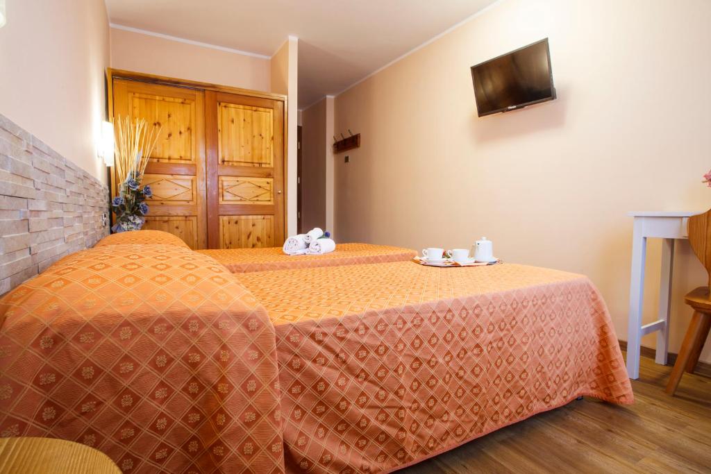 Postel nebo postele na pokoji v ubytování Hotel Olimpic