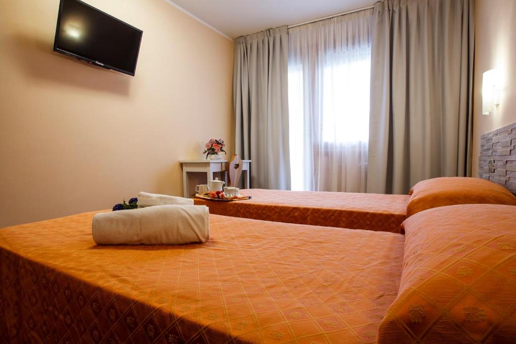 Postel nebo postele na pokoji v ubytování Hotel Olimpic