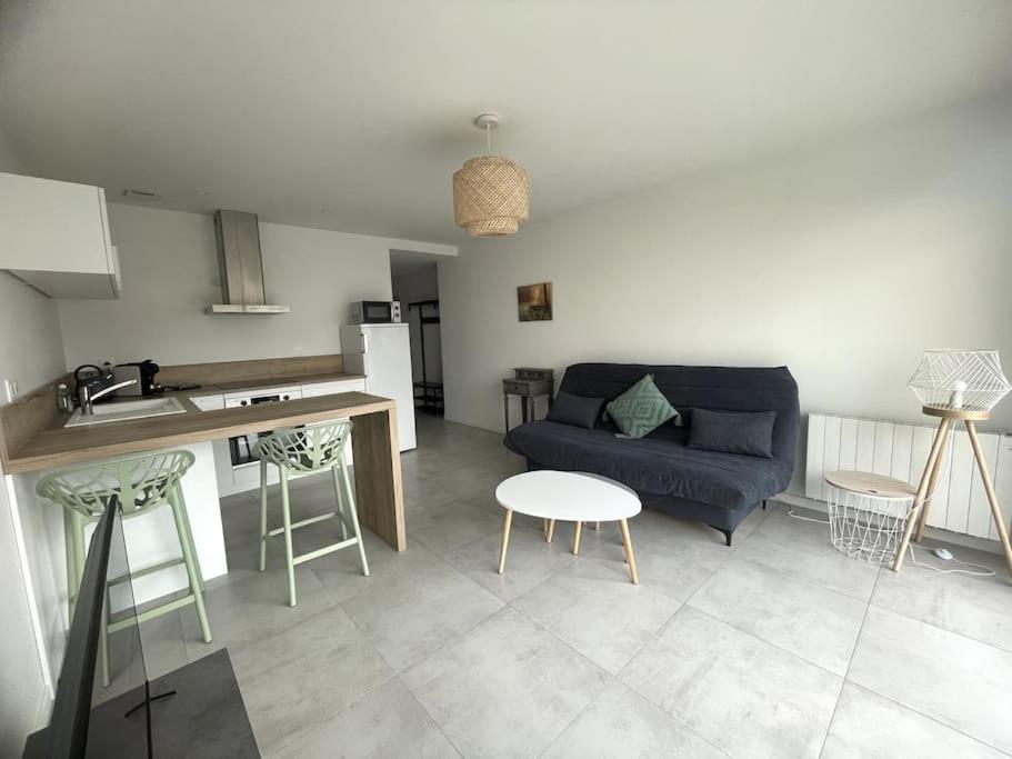 une cuisine et un salon avec un canapé et une table dans l'établissement À proximité immédiate de la mer 2, à Dunkerque
