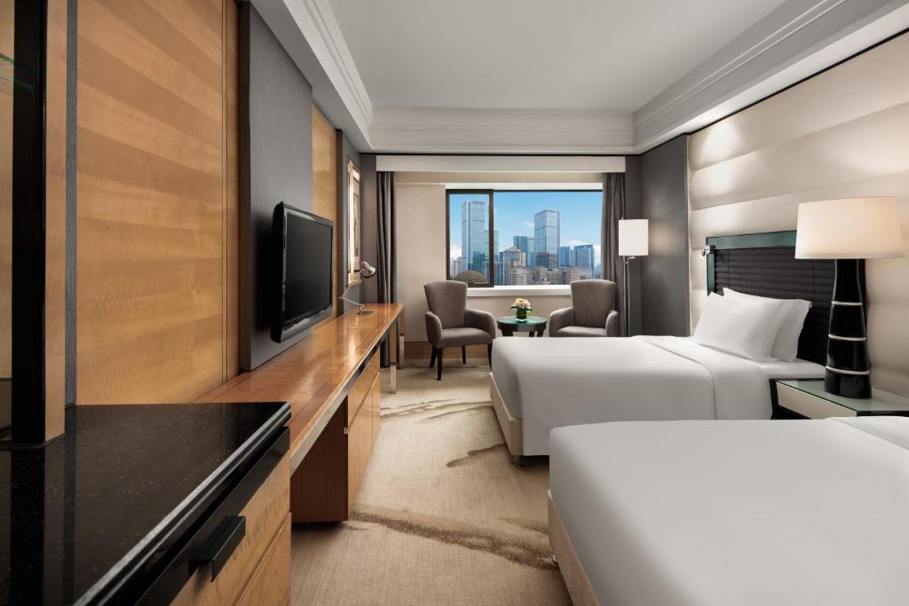 a hotel room with a bed and a television at Crowne Plaza Chengdu City Center by IHG in Chengdu